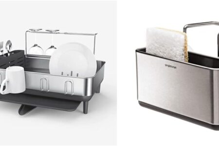 simplehuman steel frame dish rack full of plates draining into a sink
