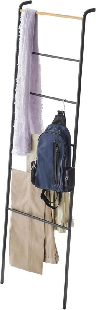 yamazaki leaning ladder rack in white leaning against a bedroom wall with folded blankets