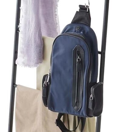 yamazaki leaning ladder rack in white leaning against a bedroom wall with folded blankets