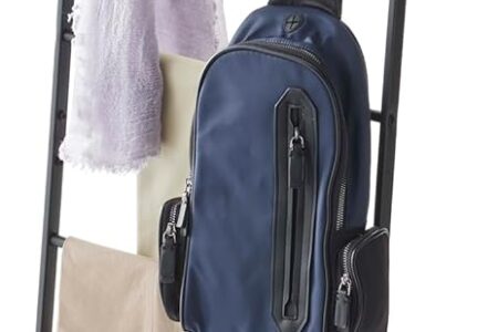 yamazaki leaning ladder rack in white leaning against a bedroom wall with folded blankets