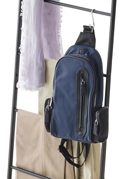 yamazaki leaning ladder rack in white leaning against a bedroom wall with folded blankets