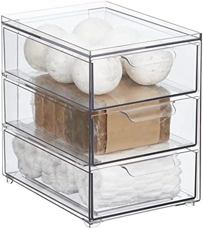 mdesign under sink organizer holding cleaning bottles next to pipes