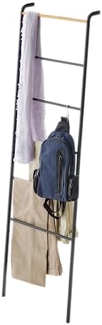 yamazaki leaning ladder rack in a small bathroom holding folded towels